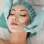Woman doing liposuction on her face.