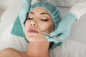 Woman doing liposuction on her face.